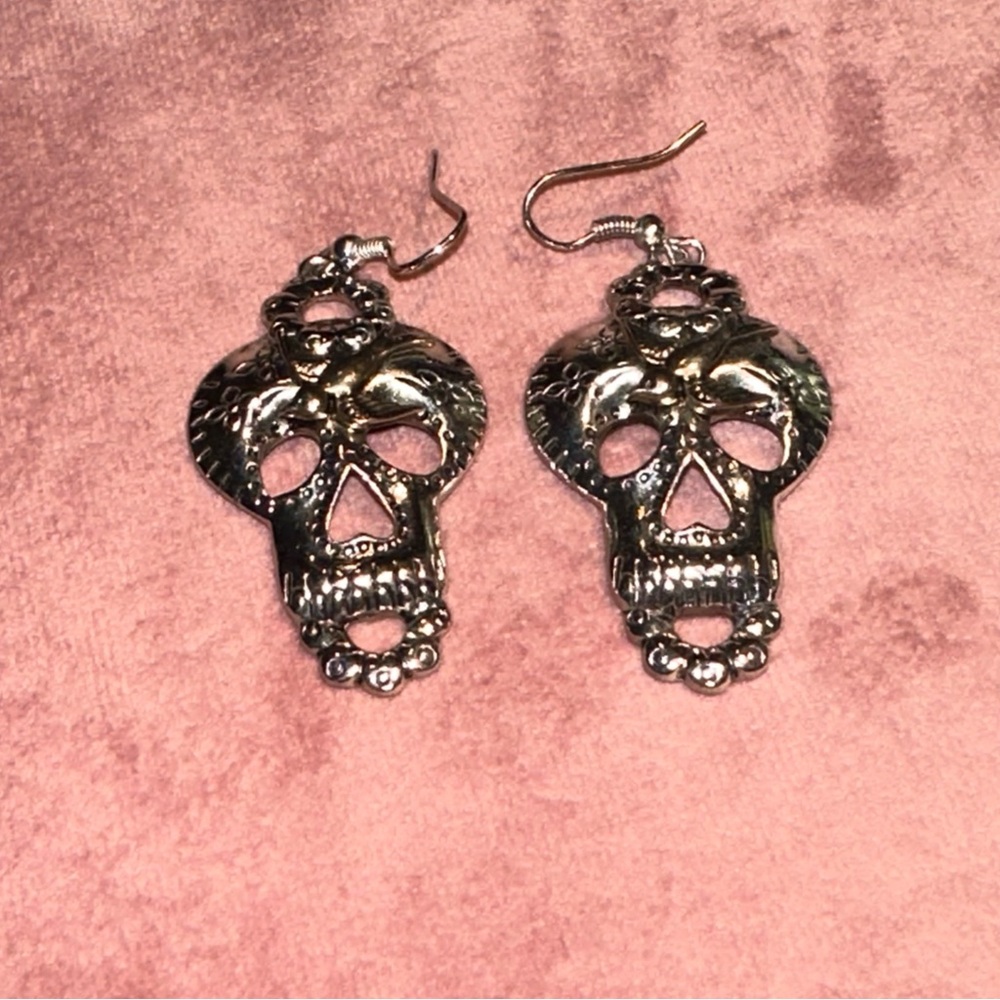Silver toned sugar skull earrings with swallow